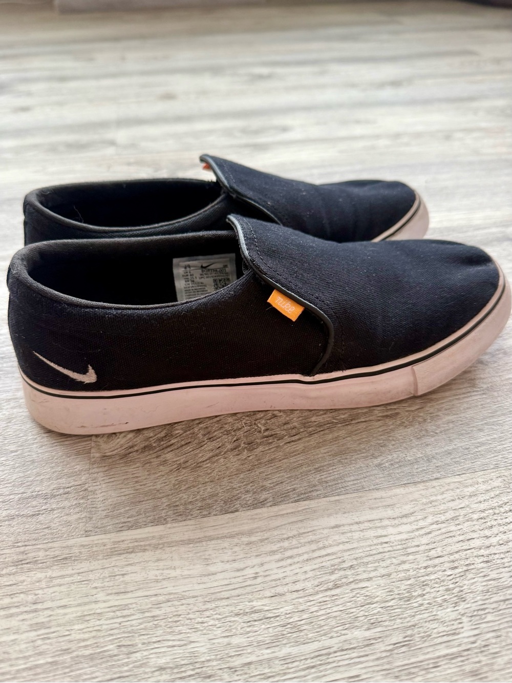 Nike Black Slip-On Canvas Sneakers with White Soles and Orange Tab